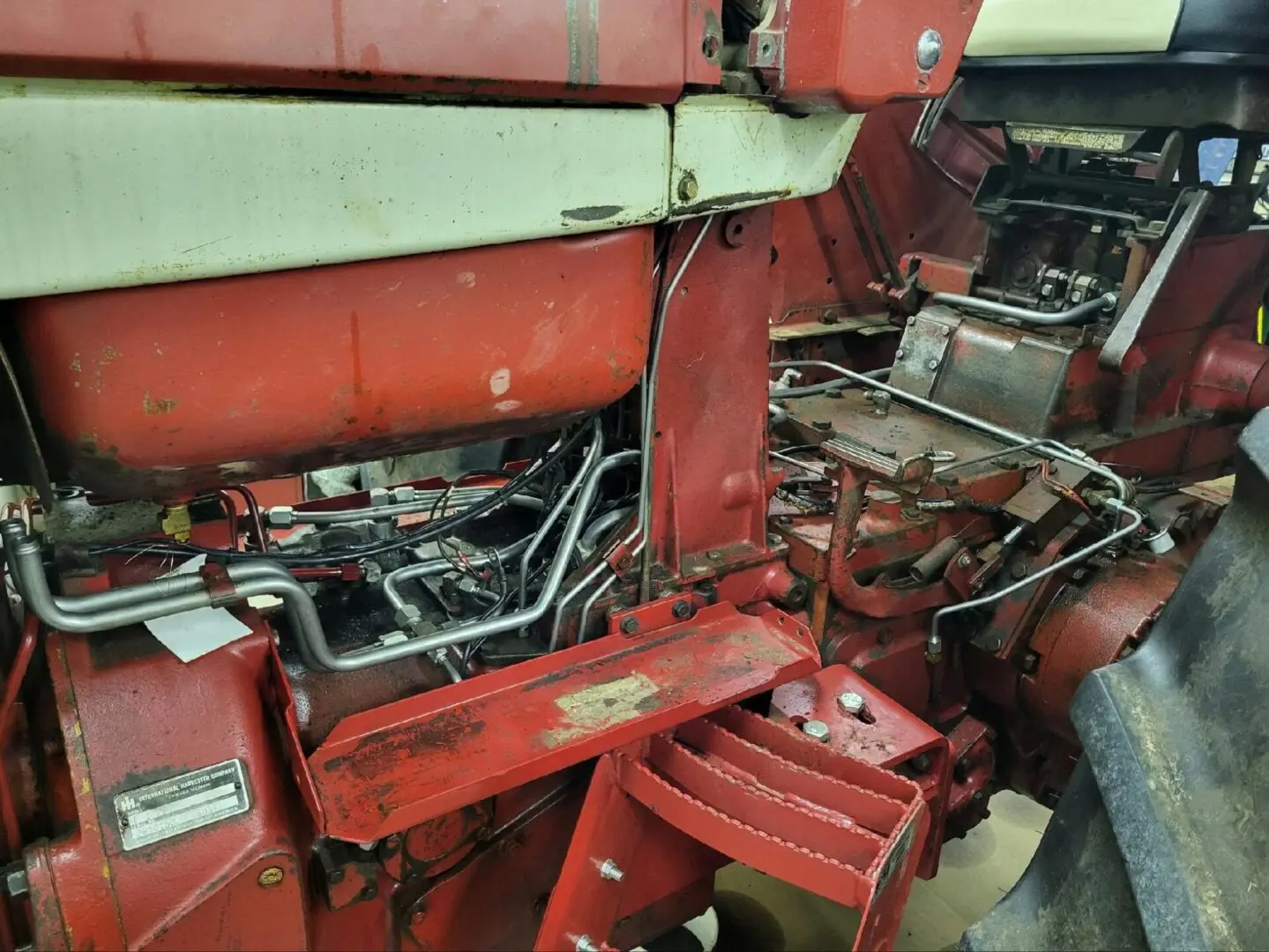 A red tractor engine in a factory.